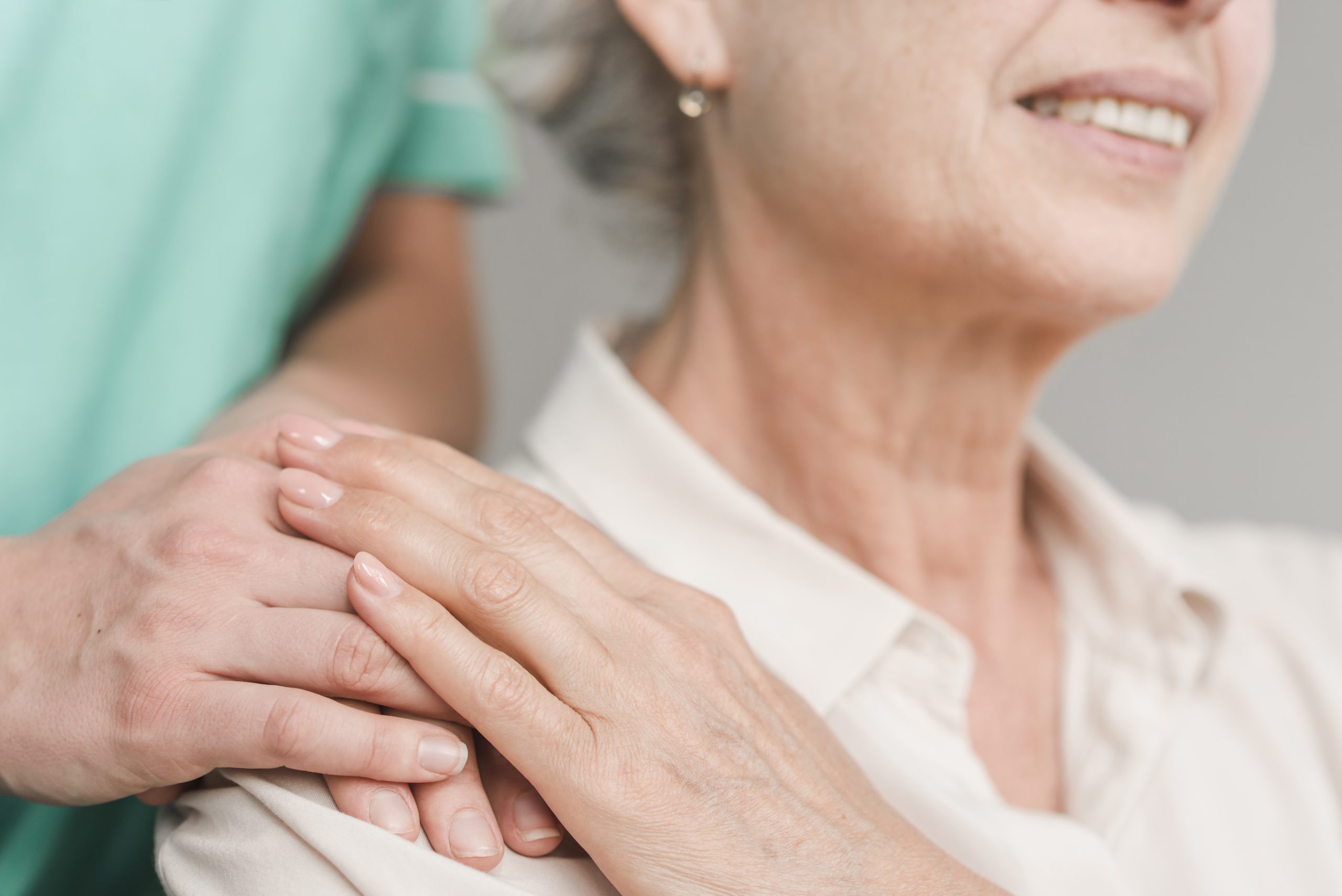 home health aide with hand on senior's shoulder