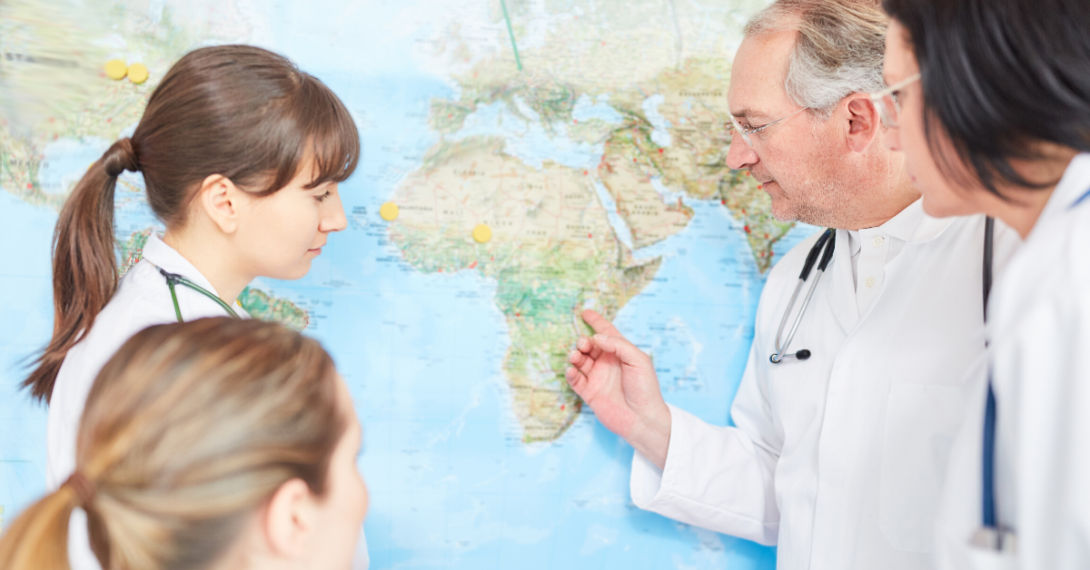 Team of Doctors With World Map Lookingo Into Africa